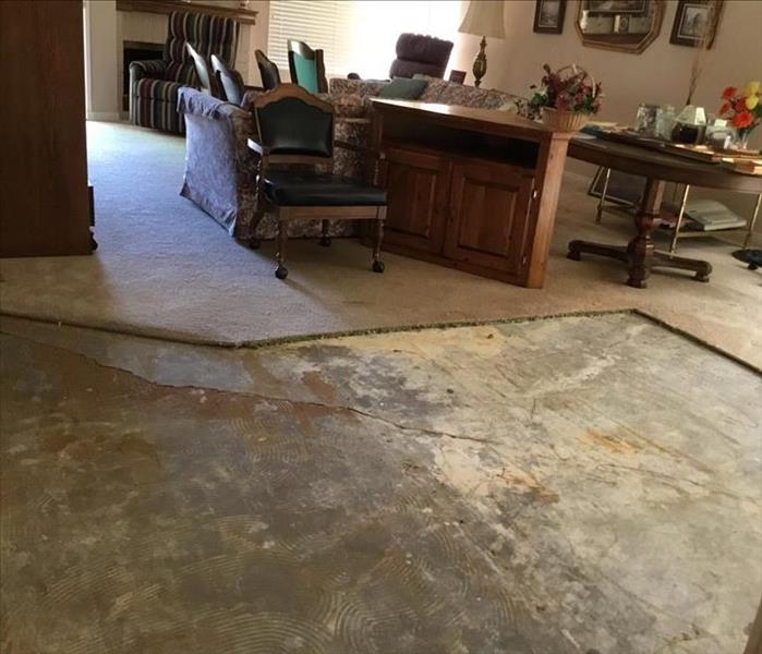 Image of same family room with water damaged wood floors removed
