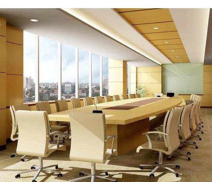 White conference table in an office with glass windows. 